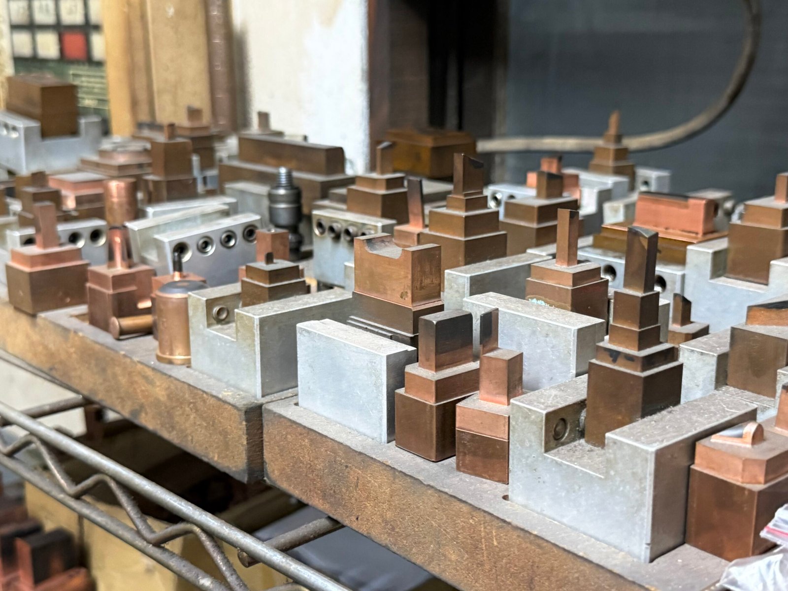 copper EDM electrodes for injection mold tooling arranged on rack - Emberon